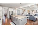 Spacious kitchen with a large island, stainless appliances, hardwood floors, and an open floor plan at 11618 Macallano Dr, Charlotte, NC 28215