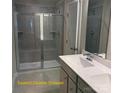 Well-lit bathroom features double sinks, a glass-enclosed shower with seating, and modern fixtures at 1598 Respect St, Concord, NC 28027