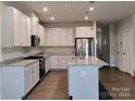 Modern kitchen features granite countertops, stainless steel appliances, and a large island at 1598 Respect St, Concord, NC 28027