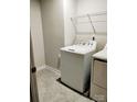 Bright laundry room with a washer, dryer, tile flooring, and ample storage space at 1598 Respect St, Concord, NC 28027