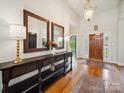 Elegant foyer with hardwood floors, console table, decorative lamps, and grand entry door at 2616 Carmarthen Ct, Matthews, NC 28104