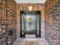 Attractive front door featuring brick surround, decorative wreath, and clear house number at 2616 Carmarthen Ct, Matthews, NC 28104
