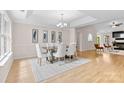 Bright dining room boasts hardwood floors, modern chandelier, and stylish decor at 3008 Cornflower Ln, Indian Trail, NC 28079