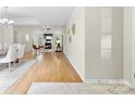 Open floor plan showcasing hardwood flooring throughout dining, living, and entryway at 3008 Cornflower Ln, Indian Trail, NC 28079