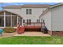 Backyard featuring a screened porch, wood deck, patio, and stainless-steel grill at 3830 Waters Reach Ln, Indian Trail, NC 28079