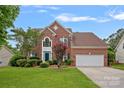 Charming two-story brick home featuring a well-maintained lawn at 3830 Waters Reach Ln, Indian Trail, NC 28079
