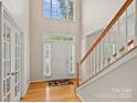 Bright foyer featuring hardwood floors, high ceilings, and a staircase at 3830 Waters Reach Ln, Indian Trail, NC 28079