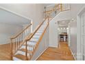 Elegant staircase with hardwood floors and white railings at 3830 Waters Reach Ln, Indian Trail, NC 28079