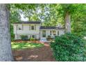 Charming home with a well-maintained lawn, mature trees, and inviting front entrance at 4014 Sulkirk Rd, Charlotte, NC 28210