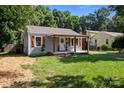 Charming single-story home featuring a welcoming front porch and shuttered windows at 405 E 18Th St, Kannapolis, NC 28083