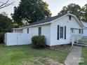 Back view of house featuring fenced backyard and walkway to the left side of the home at 407 W Mill St, Landis, NC 28088