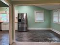 Open-concept living area showcasing stylish wood-look floors and stainless steel refrigerator at 407 W Mill St, Landis, NC 28088