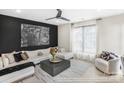 Bright living room features a modern sofa, stylish decor, and a large window with natural light at 411 Devender Ne Ln # 5, Charlotte, NC 28217