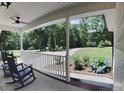 Inviting front porch featuring classic rocking chairs and a serene view of the yard at 5322 Bridgeview Dr, Iron Station, NC 28080