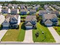 A quiet neighborhood featuring manicured lawns and mature trees in a Gathering-friendly community at 6156 Kilchurn Dr, Fort Mill, SC 29707