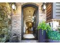 Welcoming entryway with decorative black door, brick exterior, and views into the light and bright living spaces at 617 Beauhaven Ln, Waxhaw, NC 28173