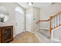 Inviting foyer with tile flooring, a staircase with wooden banister, and a front door with arched window at 7007 Creft Cir, Indian Trail, NC 28079