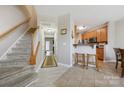 Open-concept hallway adjacent to the kitchen with wood flooring and staircase leading to the upper level at 7007 Creft Cir, Indian Trail, NC 28079