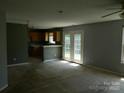 Open-concept living room with access to the kitchen and backyard through French doors at 10516 Pickerel Ln, Charlotte, NC 28213