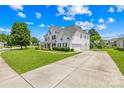 Inviting home featuring a driveway, lush lawn, and classic curb appeal at 112 Doyle Farm Ln, Mooresville, NC 28115