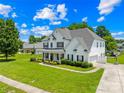 Spacious home with a large yard, driveway, and manicured landscaping at 112 Doyle Farm Ln, Mooresville, NC 28115