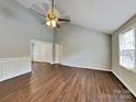 Inviting living room with vaulted ceilings, a ceiling fan, and wood-look flooring providing an open and airy space at 120 Todd Nw Dr, Concord, NC 28025