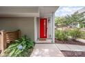 Inviting front entrance featuring a vibrant red door and neat landscaping at 1207 E 36Th St, Charlotte, NC 28205