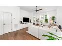 Inviting living room with built-in shelving, a large screen TV, wood flooring, and plenty of natural light at 1207 E 36Th St, Charlotte, NC 28205