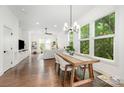 Open concept living/dining with hardwood floors, neutral decor, and lots of natural light at 1207 E 36Th St, Charlotte, NC 28205