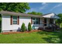 Traditional single story home showcasing a well manicured lawn and cozy front porch at 1212 Frank Ext, Rock Hill, SC 29730