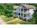 Two-story home with double front porches and manicured lawn at 12304 Huntersville Concord Rd, Huntersville, NC 28078