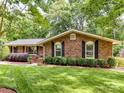 Lovely brick home featuring lush landscaping and well-manicured lawn providing a serene and inviting atmosphere at 13617 Lake Bluff Dr, Matthews, NC 28105