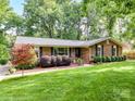 Beautiful brick home with a well-maintained lawn and mature landscaping, creating a welcoming entrance at 13617 Lake Bluff Dr, Matthews, NC 28105