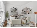 Bright staged office featuring a modern desk, stylish decor, and a comfortable seating area at 15400 Groveland St, Huntersville, NC 28078