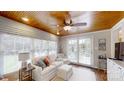 Bright sun room with wood ceilings, lots of windows, and comfortable seating at 1695 Arden Dr, Lincolnton, NC 28092