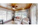 Bright sun room with wood ceilings, lots of windows, and comfortable seating at 1695 Arden Dr, Lincolnton, NC 28092
