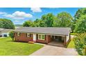 Charming one-story brick home with a well-manicured lawn and a convenient carport at 1837 6Th Nw Ave, Hickory, NC 28601
