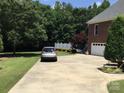Long driveway leads to a spacious home with a side-entry garage, offering privacy and ample parking at 1842 Caroline Way, Fort Mill, SC 29715