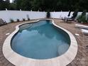 Inviting in-ground pool surrounded by a stylish brick patio, ideal for outdoor entertaining and relaxation at 1842 Caroline Way, Fort Mill, SC 29715