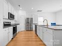 Bright kitchen with stainless steel appliances, granite countertops, and ample cabinet space at 2011 Valdosta Way, Charlotte, NC 28215