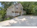 View of the home, and long driveway leading to the residence, surrounded by lush greenery at 202 Glenn Ave, Kannapolis, NC 28081