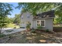 View of the home's side exterior, featuring the yard, driveway, and landscaping at 202 Glenn Ave, Kannapolis, NC 28081