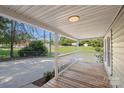 Inviting front porch with wooden flooring, white railing, and a view of the surrounding landscape at 202 Glenn Ave, Kannapolis, NC 28081