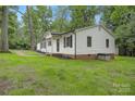 Exterior view of home with white siding, brick foundation, and well-manicured lawn at 240 Swink Ave, Salisbury, NC 28147