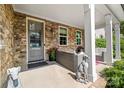 Inviting front porch with stone accents, comfortable seating, and charming decor at 2501 Christenbury Hall Nw Ct, Concord, NC 28027