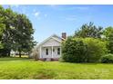 Inviting one-story residence boasting lush green lawn, brick chimney, and mature trees offering shade at 2519 2Nd Sw Ave, Hickory, NC 28602