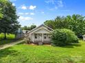 Quaint home with a lush yard, featuring a covered porch and mature trees for privacy and curb appeal at 2519 2Nd Sw Ave, Hickory, NC 28602