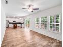 Open-concept living room and kitchen with stainless appliances, island, and access to the outdoor deck at 2612 Cold Springs Rd, Concord, NC 28025