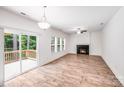 Bright living room features wood floors, fireplace, neutral paint, and glass doors leading to deck at 2612 Cold Springs Rd, Concord, NC 28025