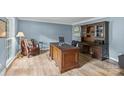 Spacious office with hardwood floors, large desk, and custom built-in shelving at 2917 Rustic Ln, Charlotte, NC 28210